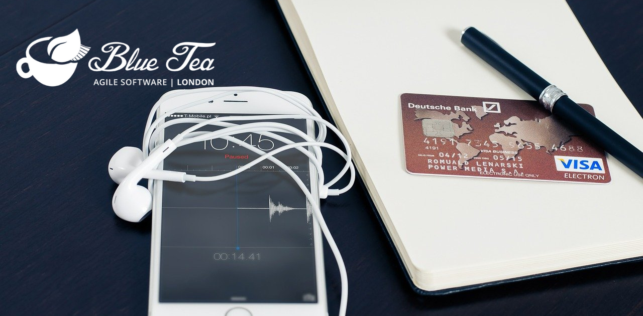 phone on table with a pen and debit card